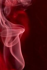 Smoke, smoke rising and creating beautiful shapes and a red background, Selective focus.