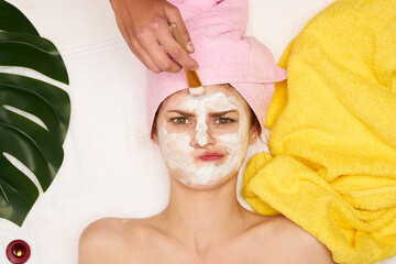 attractive woman face mask skin cleansing palm leaf view from above