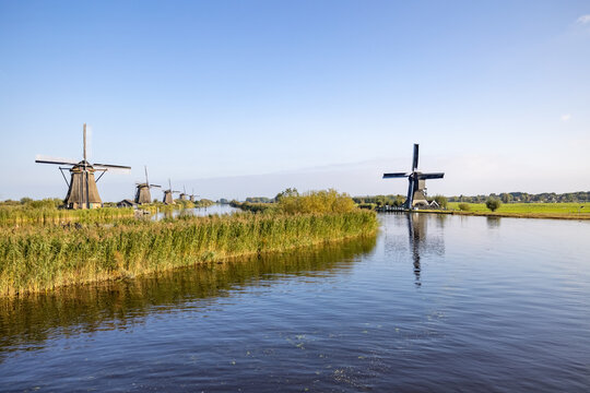 Horizontal picture of the famous Dutch windmills at Kinderdijk, a UNESCO world heritage site. On the photo are six of the 19 windmills at Kinderdijk, South Holland, the Netherlands, which are built in