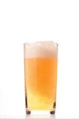 Glass of fresh beer with cap of foam isolated on a white background