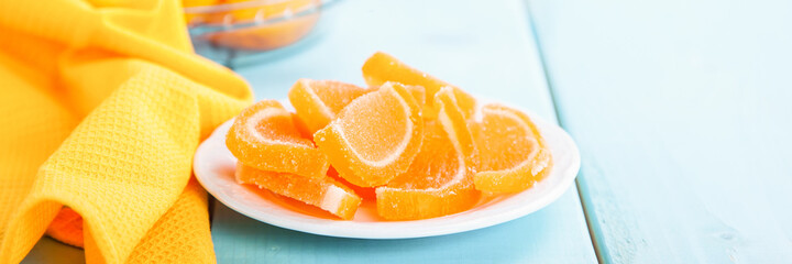 Fruit jelly candies  on blue background. Selective focus. Copy space.