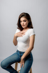 Beautiful female model . High fashion portrait&nbsp;sits in a light studio., isolated on white background.