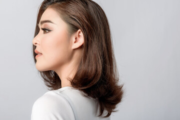 Fototapeta premium Beautiful female model . High fashion portrait&nbsp;sits in a light studio., isolated on white background.