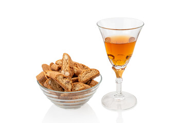Cantuccini almond cookies in glass cup with glass of Vin Santo sweet wine isolated on white. Typical Tuscan products, Italy. Copy space