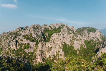 Scenic landscape view of limestone mountain with cliff in tropical forest.