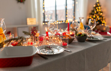 eating, winter holidays and celebration concept - close up of table serving for christmas dinner party at home