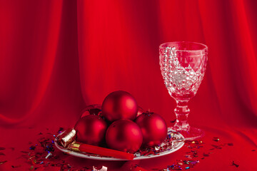 New years still life party themed image of holiday decorations. Close up of the set decor for Christmas party on the red cloth. Vintage style holidays image. Christmas card, poster with copy space.