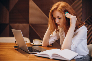 Business woman stressed with headache wirking on computer