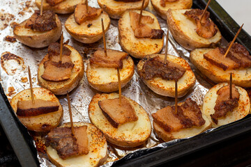 baked potatoes in the oven, close-up on a pan