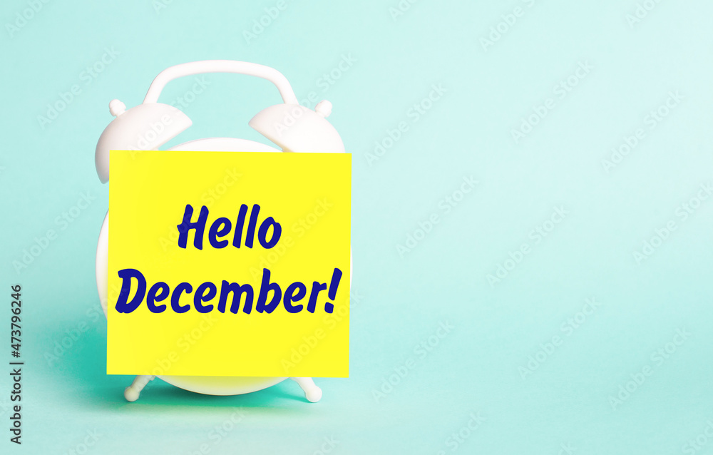 Poster on a blue background - a white alarm clock with a yellow sticker for notes with the text hello decem