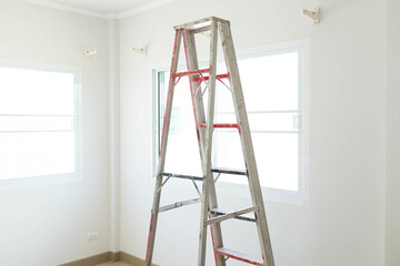 Aluminum foldable ladder in white room