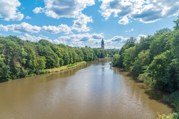 Fototapeta premium Aura river between trees at summer time in Finland.