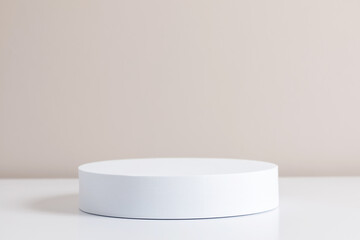 White round pedestal podium mockup on beige background.
