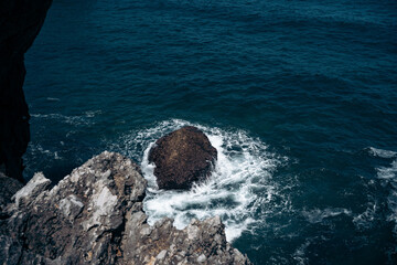 the sea striking the rocks of the cliff with bravery