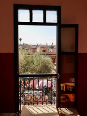 Marrakech, Morocco, 24.10.2021. Panoramic view of Place des Epices, spices square in the Medina, seen through the door of popular Marrakech hangout Cafe des Epices.