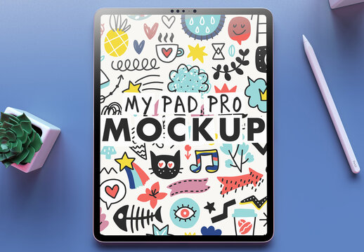 My Pad Pro Tablet Mockup on a Clean Blue Desk and a Succulent Flower on Over the Head View