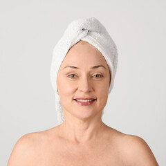 Portrait of cheerful woman with towel on head