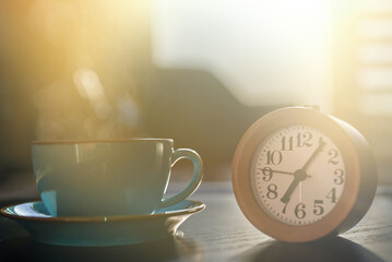 Morning at seven o'clock. Clock and a cup of tea.