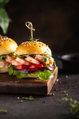 Delisious burger with shrimps on a wooden board