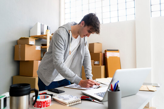 Businessman checking QR codes at desk in office