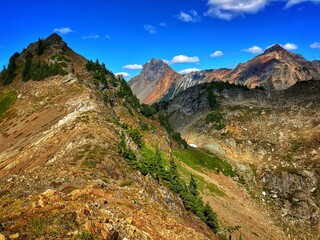 landscape with mountains, blue sky and trees