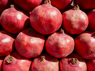 Close up of healthy ripe pomegranates on market stand. Marrakech, Morocco.