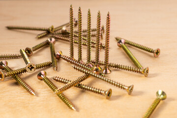 universal screws for wood on a wooden background