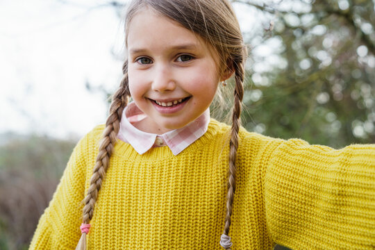 Cute girl in sweater smiling