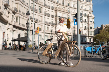 Fototapeta premium Female with bicycle in city center