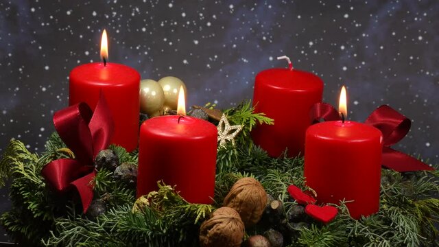 advent wreath with 3 burning candles on turn table