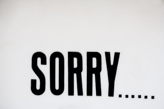SORRY... sign, close-up with full frame background
