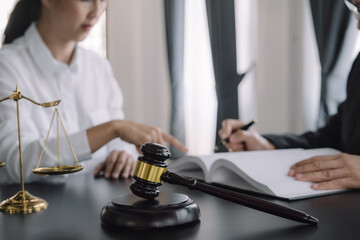 Judge gavel with Justice lawyers having team meeting at law firm background. Concepts of Law and Legal services.