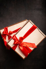 Gift boxes with red ribbon on a black background