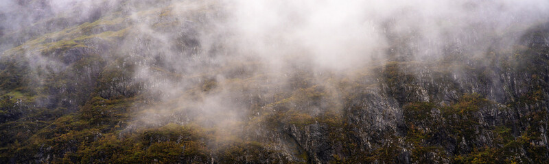 Fototapeta na wymiar Fog and mist on a mountainside in Glencoe, Scotland