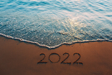 Fototapeta premium 2022 on the beach happy new year on nature background 