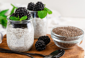 Chia seed yogurt pudding with fresh blackberries and mint leaves. Antioxidant food