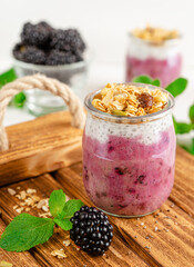 Chia yogurt jar of granola and blackberries. Healthy breakfast