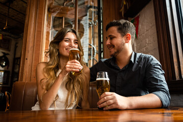 couple drinking beer in bar