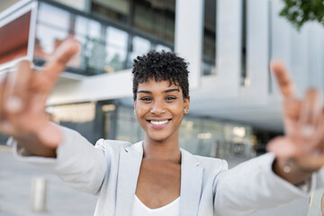 Smiling female professional making finger frame