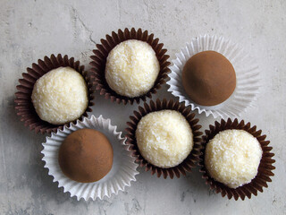 Gourmet Chocolate Truffles: white candies with coconut and white chocolate and brown dark chocolate candies with cocoa powder.