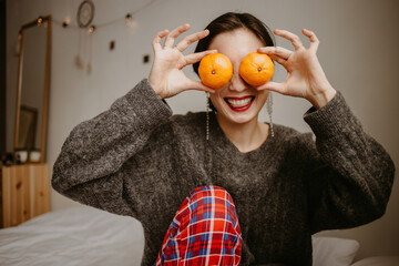woman with mandarins at home