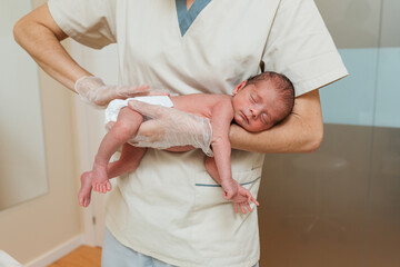 Professional physiotherapist working with a newborn baby.