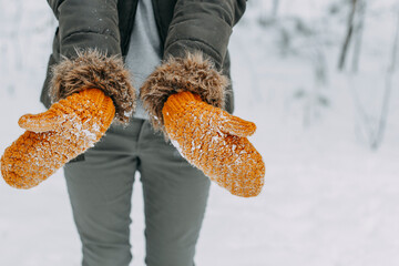 Knitted woolen mittens stained with white snow. winter time, snowball games, christmas holidays