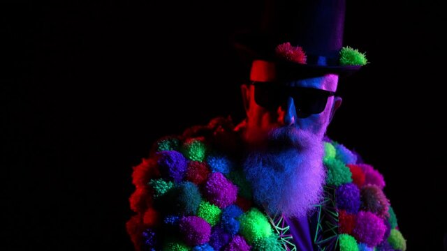 Masculine pensioner grandpa wear trend pop pom-pom costume moving under uv neon
