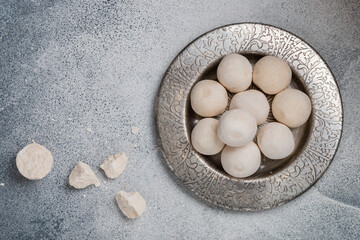 Kurut (kurt)  cheese -  traditional Asian cheese made from sheep's, goat's or cow's milk. Kazakh and Kyrgyz national food. white salty balls from dry cheese close-up. Selective focus, copy space