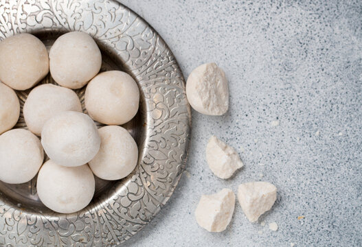 Kurut (kurt)  cheese -  traditional Asian cheese made from sheep's, goat's or cow's milk. Kazakh and Kyrgyz national food. white salty balls from dry cheese close-up. Selective focus, copy space