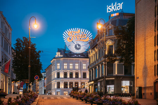 Oslo, Norway. Freia Sign In Night. Old Commercial Sign For Norwegian Chocolate Freia. Norwegian chocolate sweets manufacturing company Freia clock at Egertorget square.