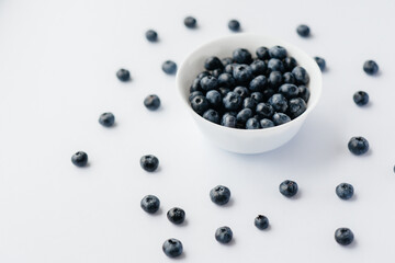 Beautiful ripe blueberries in a glass bowl on a white background. Healthy food, and vitamins.