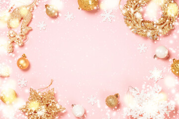 Fototapeta na wymiar Magic Christmas background at pink. White and golden christmas decorations top view. Christmas frame with holiday lights.