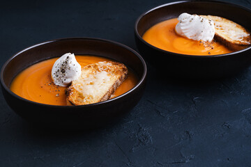 Creamy butternut soup with cream and parmesan toasts